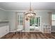 Charming dining area with a decorative chandelier, natural light, and access to the outdoors at 9836 Black Tupelo Ln, Ladson, SC 29456