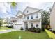 Charming two-story white home with a well-manicured lawn, a two-car garage, and a lovely second story balcony at 9836 Black Tupelo Ln, Ladson, SC 29456