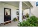 Inviting front porch with seating and greenery, showcasing the entrance and house number at 9836 Black Tupelo Ln, Ladson, SC 29456