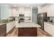 Spacious kitchen with white cabinetry, a granite-topped island, and stainless steel appliances at 9836 Black Tupelo Ln, Ladson, SC 29456