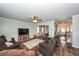 Open-concept living room boasts hardwood floors, neutral tones, and comfortable seating at 9836 Black Tupelo Ln, Ladson, SC 29456