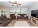 Comfortable living room with a ceiling fan, natural light, neutral tones, and plush seating arrangements at 9836 Black Tupelo Ln, Ladson, SC 29456