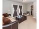 Comfortable living space with a plush sofa, ottoman, and natural light streaming in at 9836 Black Tupelo Ln, Ladson, SC 29456