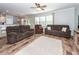 Spacious living room with hardwood floors, modern furnishings, a ceiling fan, and plenty of natural light at 9836 Black Tupelo Ln, Ladson, SC 29456