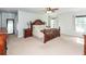 Bright main bedroom with a wooden bed frame, matching nightstands, and plenty of natural light from the windows at 9836 Black Tupelo Ln, Ladson, SC 29456