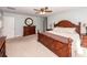 Spacious bedroom featuring a wooden bed frame, matching dresser, and neutral decor, creating a relaxing atmosphere at 9836 Black Tupelo Ln, Ladson, SC 29456