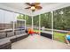 Screened patio overlooking a fenced yard with mature trees and play equipment at 9836 Black Tupelo Ln, Ladson, SC 29456