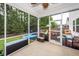 A beautiful screened porch opens to a backyard with a play set and above ground pool at 9836 Black Tupelo Ln, Ladson, SC 29456