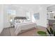 Bedroom with a large bed, stylish decor, and an ensuite bathroom at 1023 Marsh Harrier Dr # Cc3-3-5P, Ravenel, SC 29470