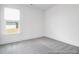 Clean, empty bedroom with a bright window and neutral carpet at 1023 Marsh Harrier Dr # Cc3-3-5P, Ravenel, SC 29470