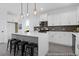 Modern kitchen with white cabinets, stainless steel appliances, a gray backsplash, and a spacious island with seating at 1023 Marsh Harrier Dr # Cc3-3-5P, Ravenel, SC 29470