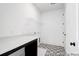 Functional laundry room with countertop, storage shelving, and patterned floors, making laundry chores a breeze at 1023 Marsh Harrier Dr # Cc3-3-5P, Ravenel, SC 29470