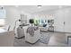 Bright living room with modern decor, natural light from large windows, and cozy seating arrangement at 1023 Marsh Harrier Dr # Cc3-3-5P, Ravenel, SC 29470