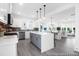 Open concept living space with dining area and kitchen, light wood flooring, and white walls for natural light at 1023 Marsh Harrier Dr # Cc3-3-5P, Ravenel, SC 29470