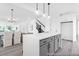 Open concept living space with dining area and kitchen, light wood flooring, and white walls for natural light at 1023 Marsh Harrier Dr # Cc3-3-5P, Ravenel, SC 29470