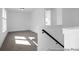 Upstairs loft with plush carpeting, natural light, and staircase, ideal for extra living space or play area at 1023 Marsh Harrier Dr # Cc3-3-5P, Ravenel, SC 29470