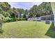 Sprawling backyard boasts lush green grass, a shed, and mature trees at 1032 Windward Rd, Charleston, SC 29412