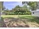 Large backyard with green grass, foliage, and a shed at 1032 Windward Rd, Charleston, SC 29412