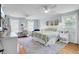 Bright, spacious bedroom with a king bed, hardwood floors, multiple windows, and a ceiling fan at 1032 Windward Rd, Charleston, SC 29412