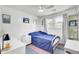 Brightly lit bedroom with a single bed, a large window, and white trim at 1032 Windward Rd, Charleston, SC 29412