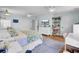 Bright primary bedroom with light blue walls, hardwood floors, and updated furniture and decor at 1032 Windward Rd, Charleston, SC 29412