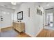 Bright entryway with hardwood floors, a stylish console table, mirror, and tasteful decor at 1032 Windward Rd, Charleston, SC 29412