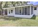 The exterior features a lovely screened porch, grass yard, and white siding at 1032 Windward Rd, Charleston, SC 29412
