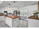 Bright kitchen features a central island with butcher block top, white cabinets, modern appliances, and stylish pendant lighting at 1032 Windward Rd, Charleston, SC 29412