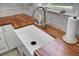 Farmhouse sink sits beside butcher block counters in a modern kitchen with white cabinets and stainless steel faucet at 1032 Windward Rd, Charleston, SC 29412