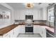 Stylish kitchen features white cabinets, stainless steel appliances, butcher block countertops, and a farmhouse sink at 1032 Windward Rd, Charleston, SC 29412