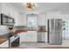 Bright kitchen features white cabinets, stainless steel appliances, butcher block countertops, and a farmhouse sink at 1032 Windward Rd, Charleston, SC 29412