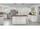 Bright kitchen features a central island with butcher block top, white cabinets, modern appliances, and stylish pendant lighting at 1032 Windward Rd, Charleston, SC 29412