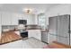 Stylish kitchen features white cabinets, stainless steel appliances, butcher block countertops, and a farmhouse sink at 1032 Windward Rd, Charleston, SC 29412