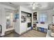A clean laundry room, featuring modern washer and dryer, storage shelves, and natural lighting at 1032 Windward Rd, Charleston, SC 29412