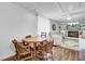 Cozy living room with a brick fireplace, seating, and a wooden dining table with chairs at 1032 Windward Rd, Charleston, SC 29412