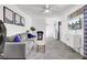Cozy living room featuring a gray sofa, light gray carpet, and wall-mounted TV at 1032 Windward Rd, Charleston, SC 29412