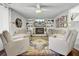Inviting living room with fireplace, comfortable seating, and a vibrant area rug on hardwood floors at 1032 Windward Rd, Charleston, SC 29412