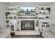 Living room with a beautiful brick fireplace with decorative shelves, a TV, and hardwood floors at 1032 Windward Rd, Charleston, SC 29412