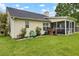 An exterior view shows a screened porch, siding, and backyard with a lush green lawn at 104 Lancaster Ct, Goose Creek, SC 29445