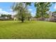 Expansive backyard featuring lush green grass, mature trees, and a quaint covered porch perfect for relaxation and outdoor enjoyment at 104 Lancaster Ct, Goose Creek, SC 29445