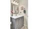 This bathroom features a vanity with gray cabinets, a white countertop, a mirror, and modern lighting fixtures at 104 Lancaster Ct, Goose Creek, SC 29445