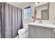 Bright bathroom featuring a shower, toilet, vanity with gray cabinets and a well-lit mirror, creating a clean and modern space at 104 Lancaster Ct, Goose Creek, SC 29445