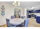 Dining area leads into a kitchen with stainless steel appliances and blue cabinets at 104 Lancaster Ct, Goose Creek, SC 29445