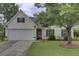 Charming single-Gathering home featuring a well-manicured lawn and a two-car garage at 104 Lancaster Ct, Goose Creek, SC 29445