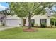 Beautiful home with a manicured lawn, inviting curb appeal, and a two-car garage at 104 Lancaster Ct, Goose Creek, SC 29445