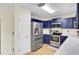 Well-lit kitchen with stainless steel appliances, blue cabinetry, and ample counter space at 104 Lancaster Ct, Goose Creek, SC 29445