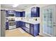 Charming kitchen with stainless steel appliances, blue cabinets, and access to patio at 104 Lancaster Ct, Goose Creek, SC 29445