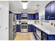 Modern kitchen with stainless steel appliances, blue cabinets, and a bright window at 104 Lancaster Ct, Goose Creek, SC 29445