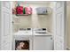Convenient laundry room with a washer, dryer, shelving, and ample storage space at 104 Lancaster Ct, Goose Creek, SC 29445