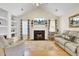 Bright living room featuring a fireplace, built-in shelving, and hardwood floors at 104 Lancaster Ct, Goose Creek, SC 29445